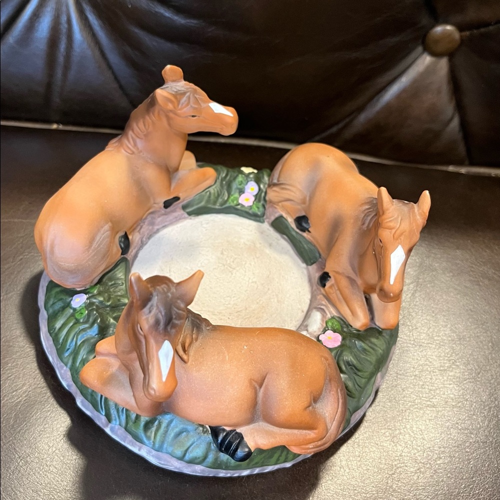 Candle holder with three horses